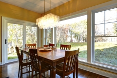 Natural light flooding a dining room with newly installed Vector Windows