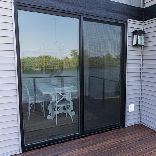 Sliding glass door in a dining room with exterior tint